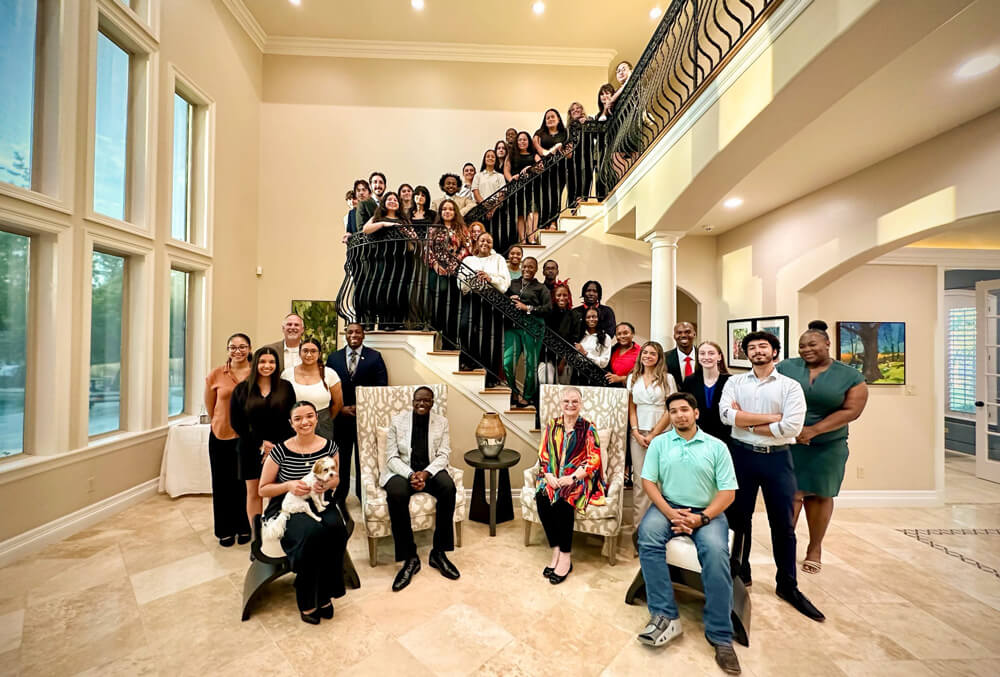 Dr. White and the SGA team fill up spiral stairs in a large, nice building.