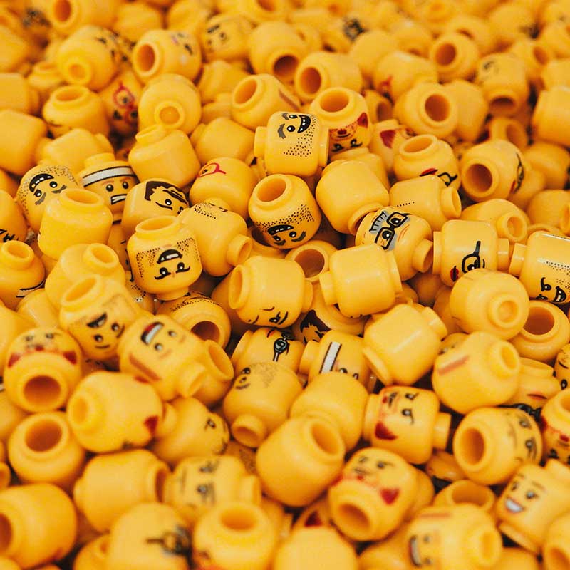 group of yellow lego heads with varying faces