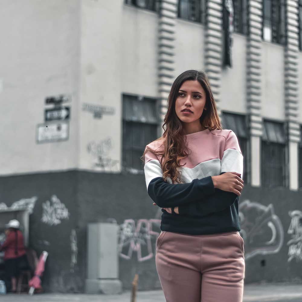 woman standing in an alley