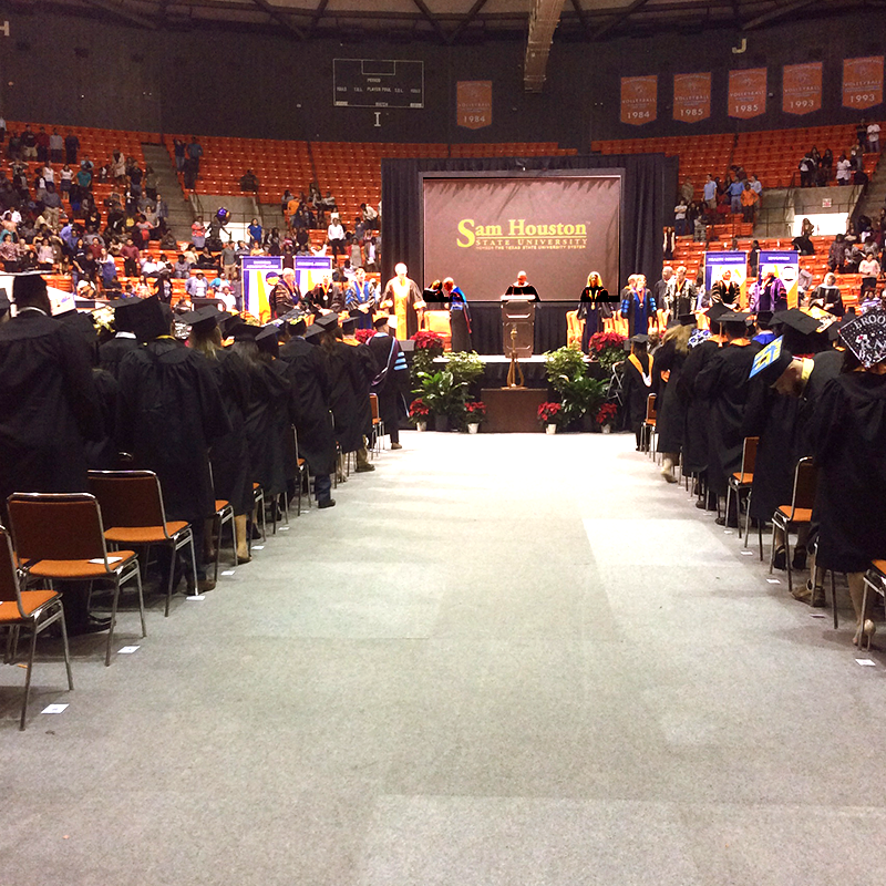 graduation stage with graduates watching