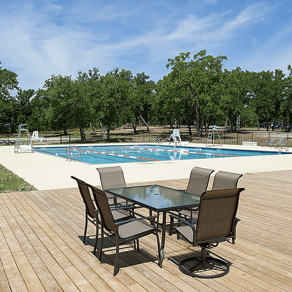 table and chairs in the pool area