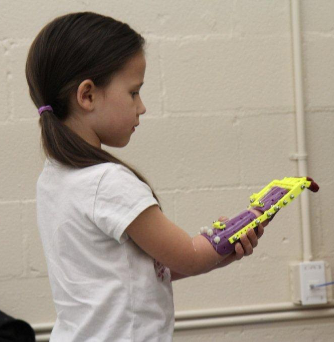 Zoe with her new hand from the Center for Innovation and Technology at SHSU