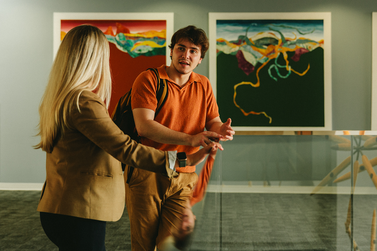 A student and professor discuss their work as they walk.