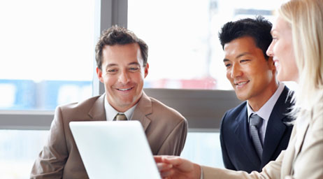 adults looking at computer