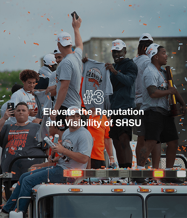 Students riding a vehicle for a spirit parade