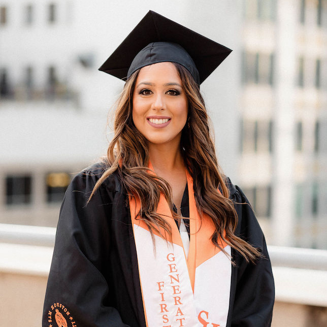 Danielle Laird brightly smiles in her graduation gown.