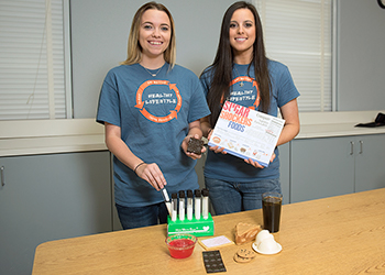 Dietetic nutritionists showing off their equipment.